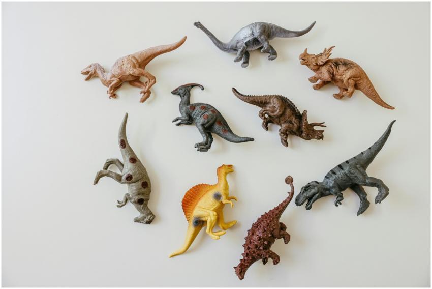 A playful flat lay of colorful dinosaur toy figure