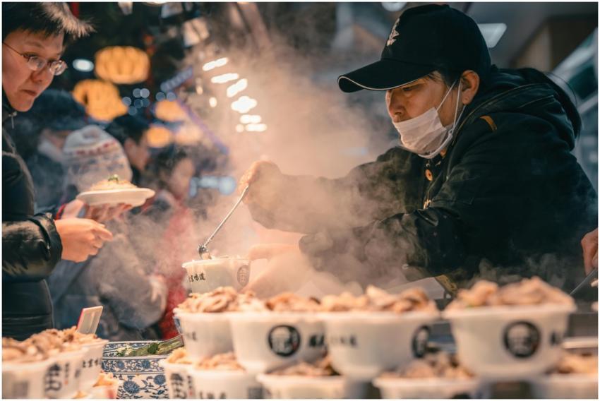 Bustling street food scene in Beijing with vendor