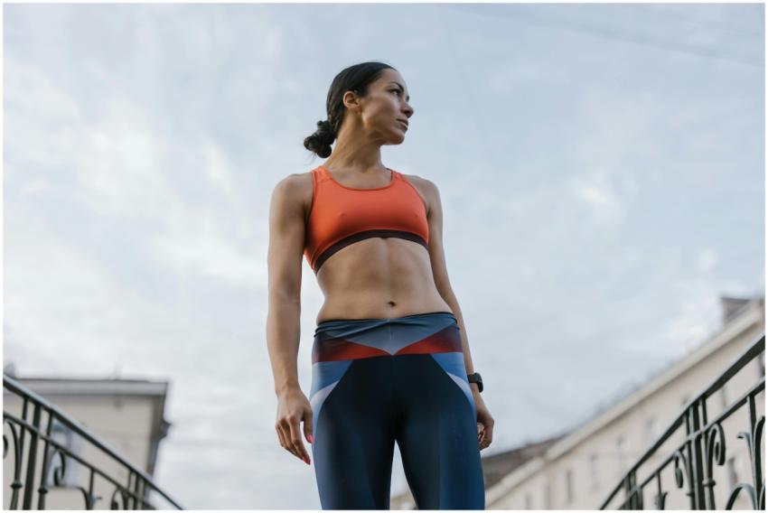 Woman in athletic attire standing confidently outd