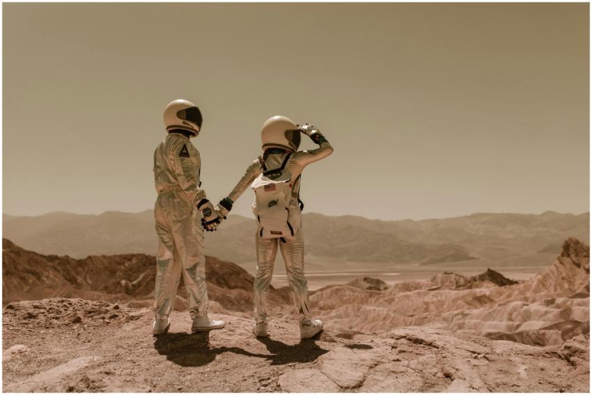 Two astronauts holding hands, exploring rocky Mars
