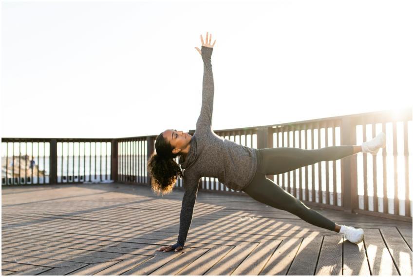 African American woman doing yoga side plank on a