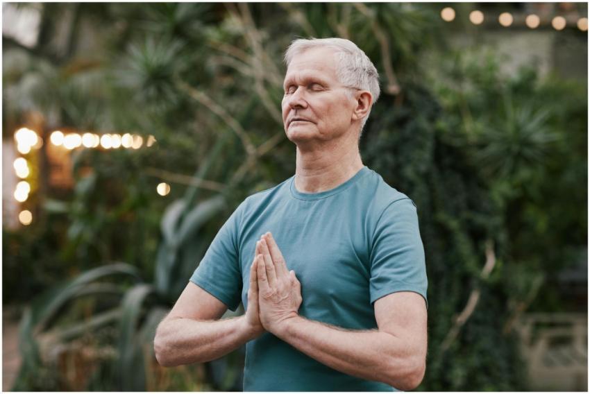 Serene elderly man meditating outdoors in a tranqu