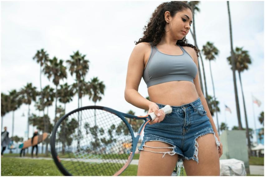 Woman in casual activewear holding a tennis racket