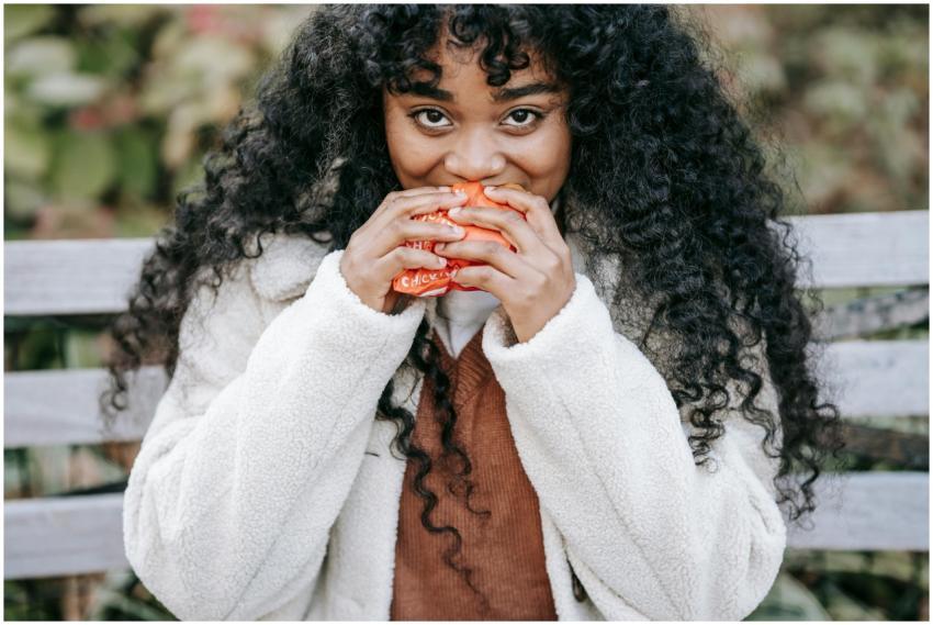 Crop hungry African American female in warm clothe