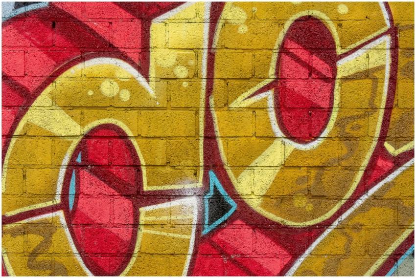 Vibrant graffiti art with red and yellow hues pain