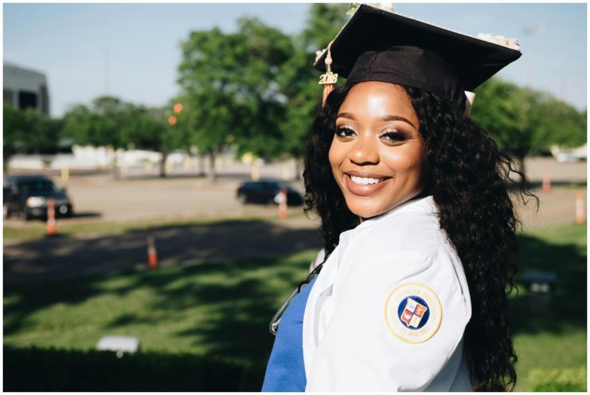 African American woman in graduation attire, smili