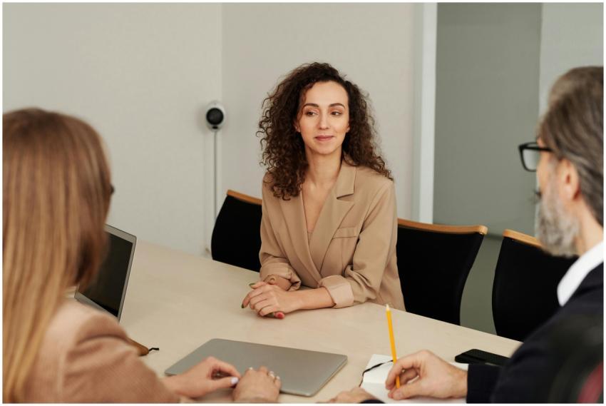 Colleagues discuss projects around a conference ta