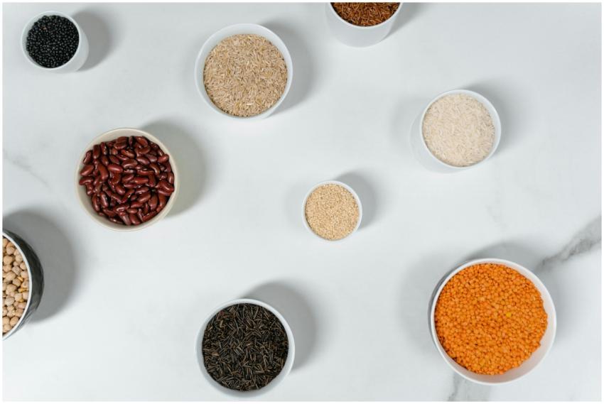 Top view of various grains and legumes in bowls on