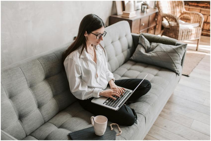 Woman in a cozy home setting working on a laptop f