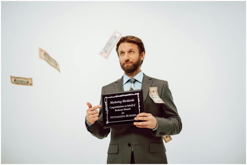 Businessman holding an award plaque, surrounded by
