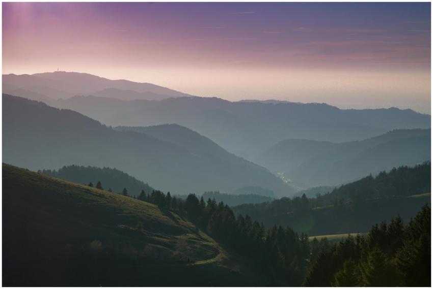 A beautiful view of rolling hills and forests unde