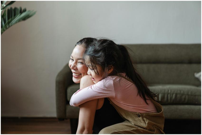 Smiling mother and daughter sharing a warm embrace