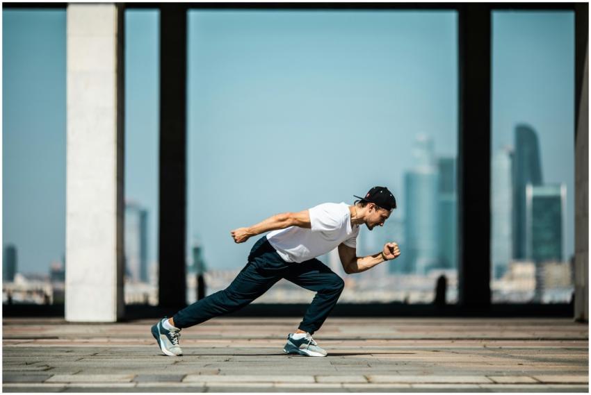 Dynamic shot of a young man sprinting outdoors in