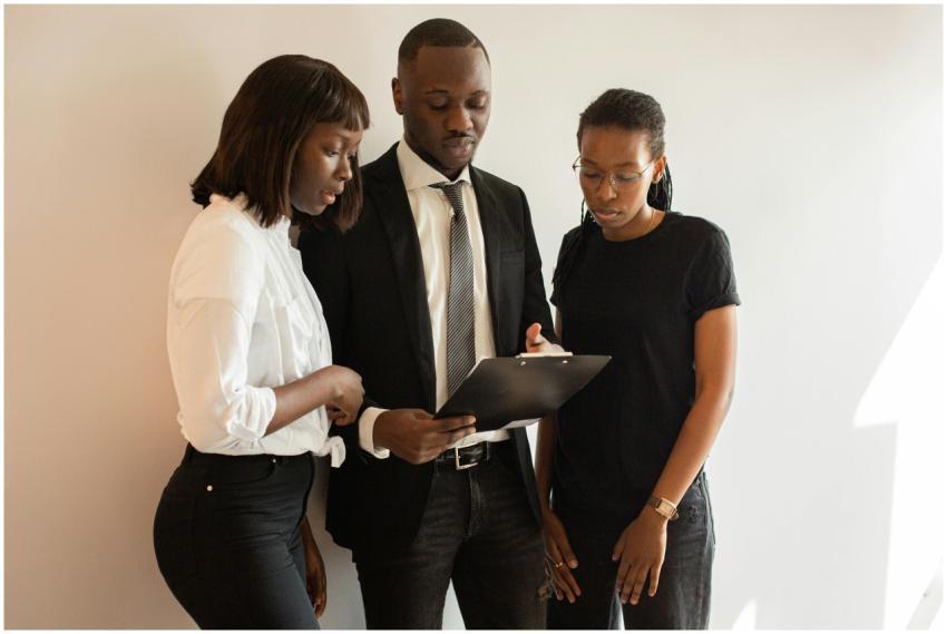 A team of professionals discussing work around a c