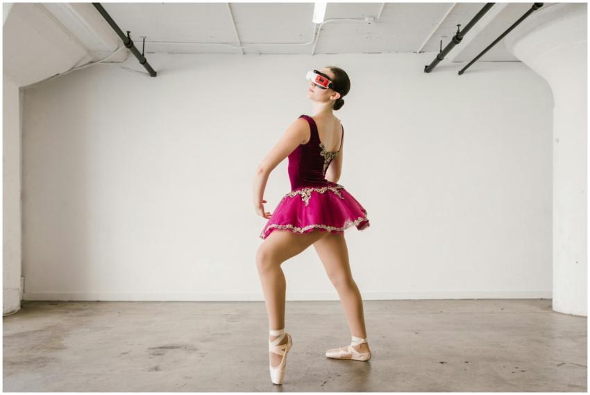 Ballet dancer in a pink tutu explores virtual real