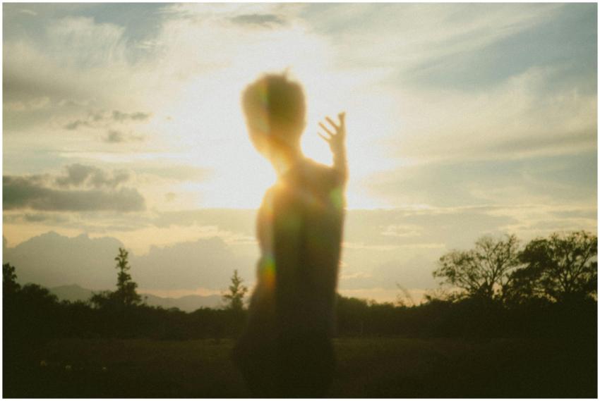 Blurred silhouette of a person with raised arm in