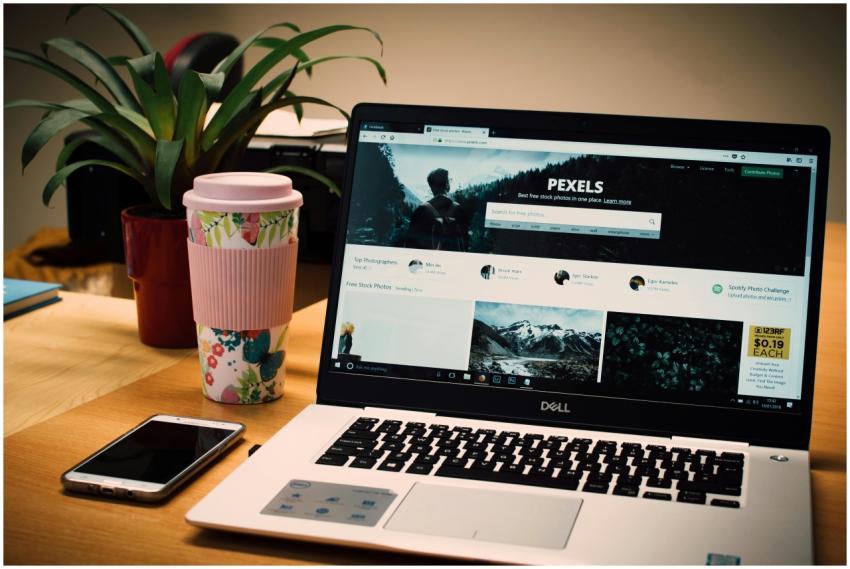 A tidy desk setting with a laptop showing a stock