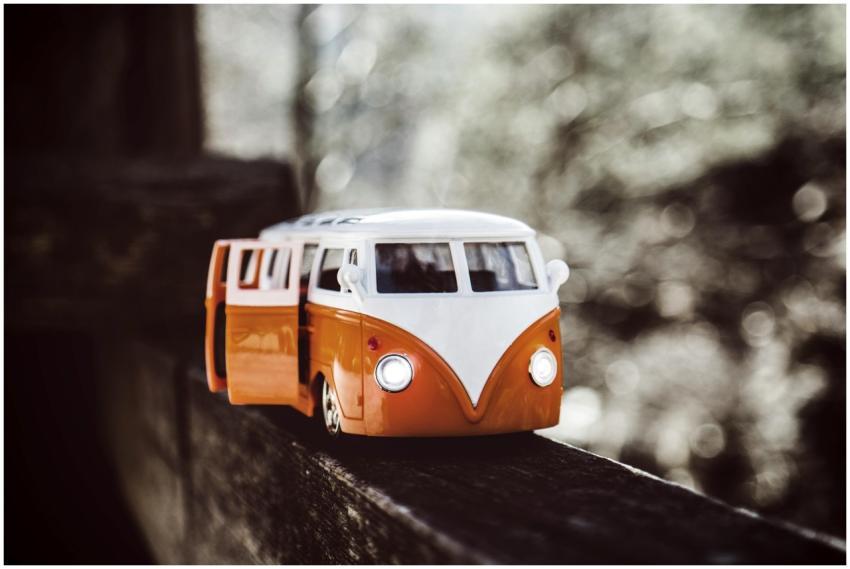 Close-up of a vintage toy campervan on a wooden be
