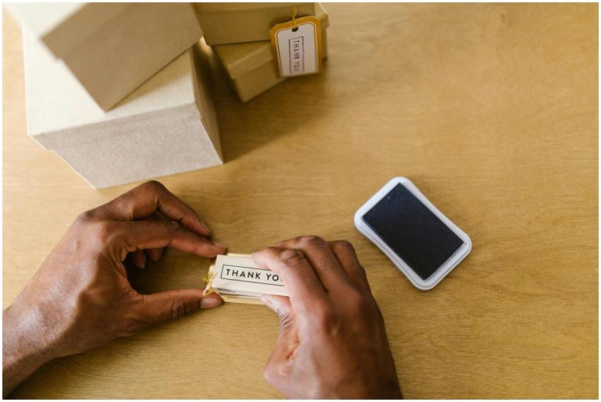 Hands of a small business owner sealing thank you