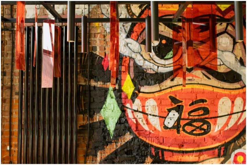 Colorful graffiti mural with modern hanging lights