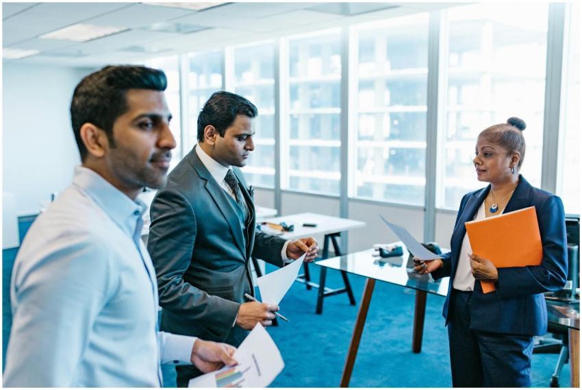 Business professionals discussing documents in a m
