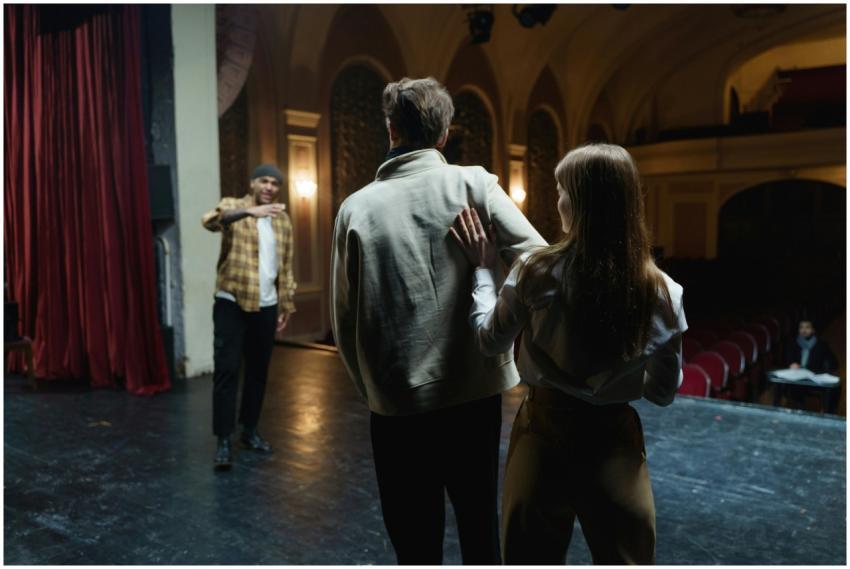 Actors in rehearsal on stage, capturing the art an