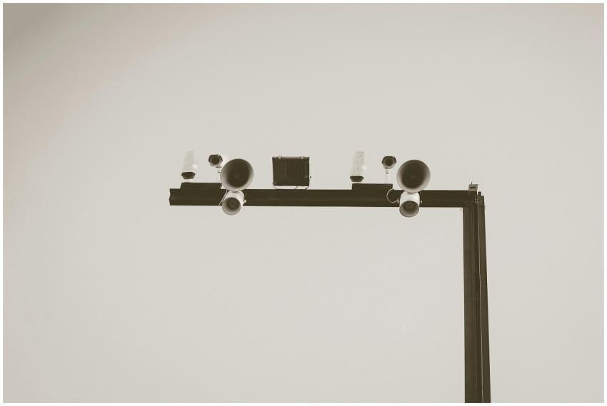 Monochrome image of CCTV cameras and speakers on a