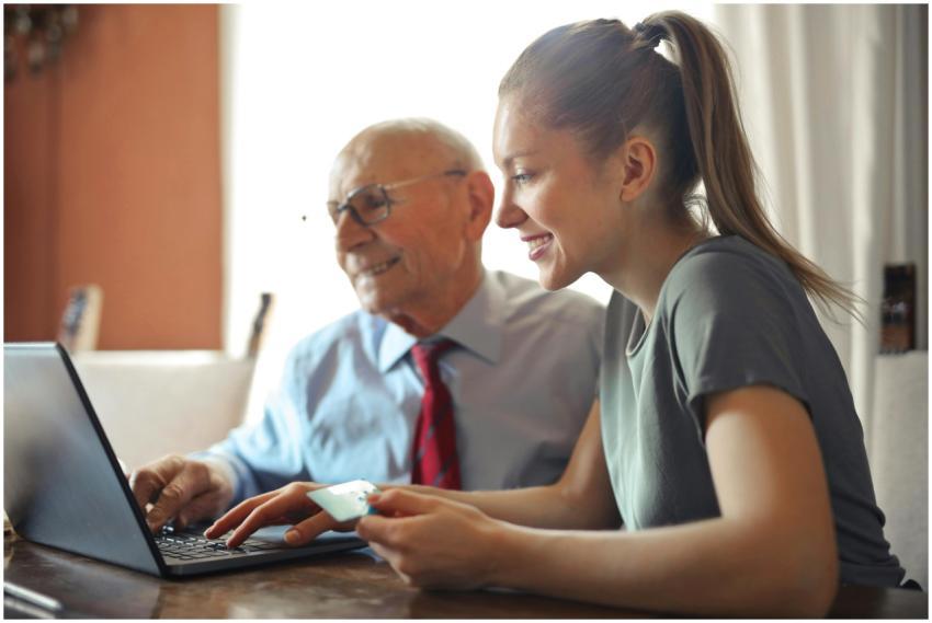 Young woman in casual clothes helping senior man i