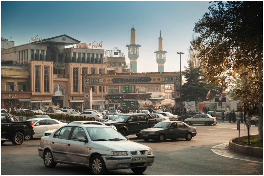 Bustling Tehran street scene with cars, mosque min