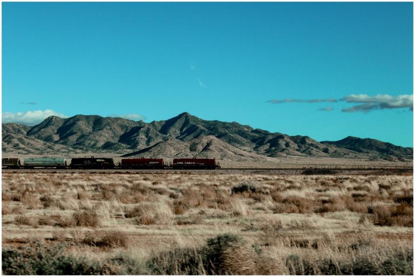 A train traveling through the arid desert plains o