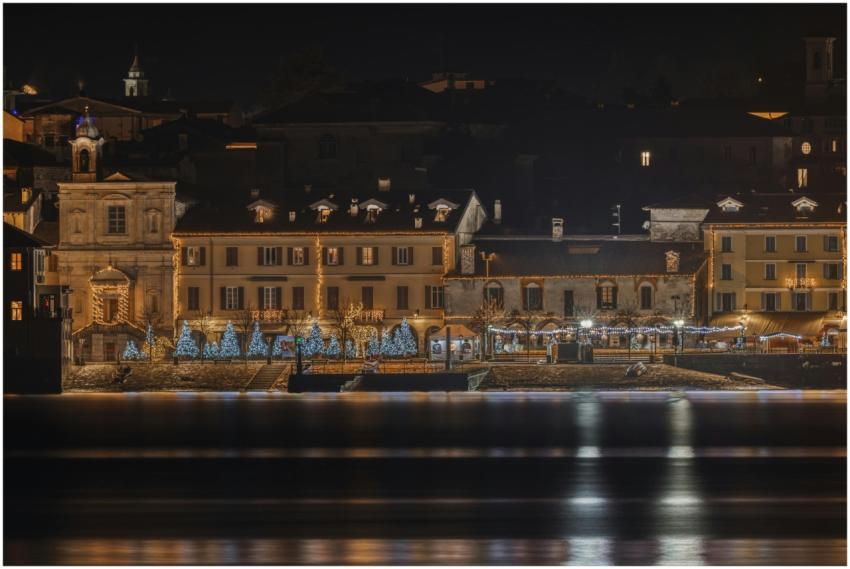 Beautiful riverside scene with holiday lights on b