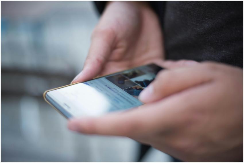 Close-up of hands using a smartphone with a touchs
