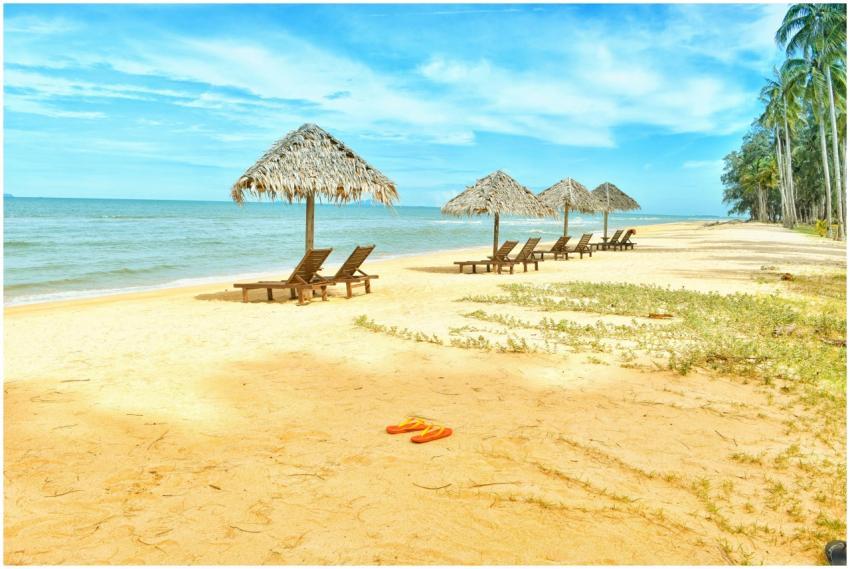 Idyllic tropical beach scene with empty lounge cha