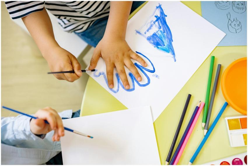 Children painting with watercolors and colored pen