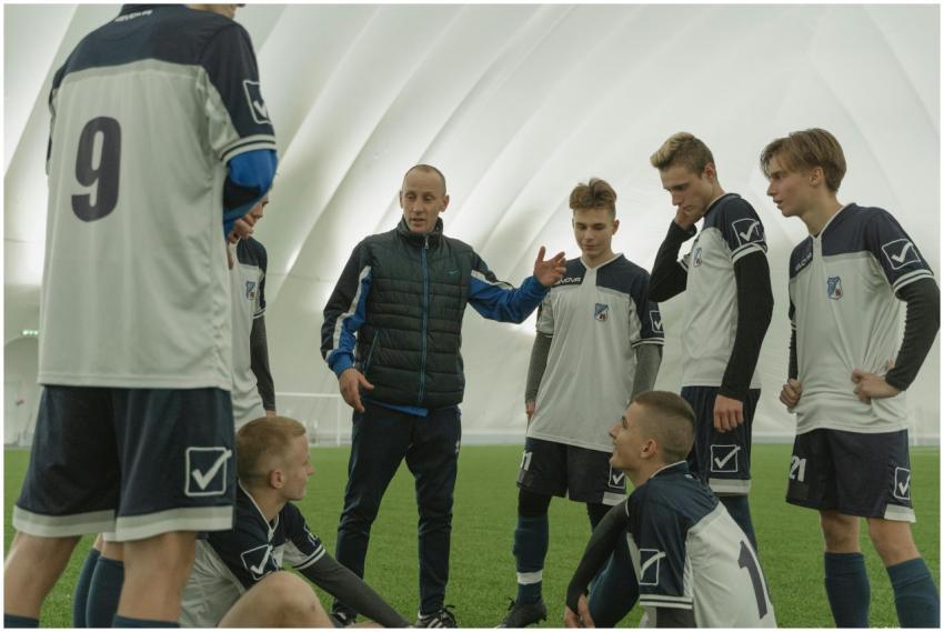 A coach passionately instructs his soccer team dur