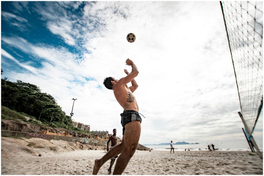 A dynamic volleyball game on a sandy beach, captur