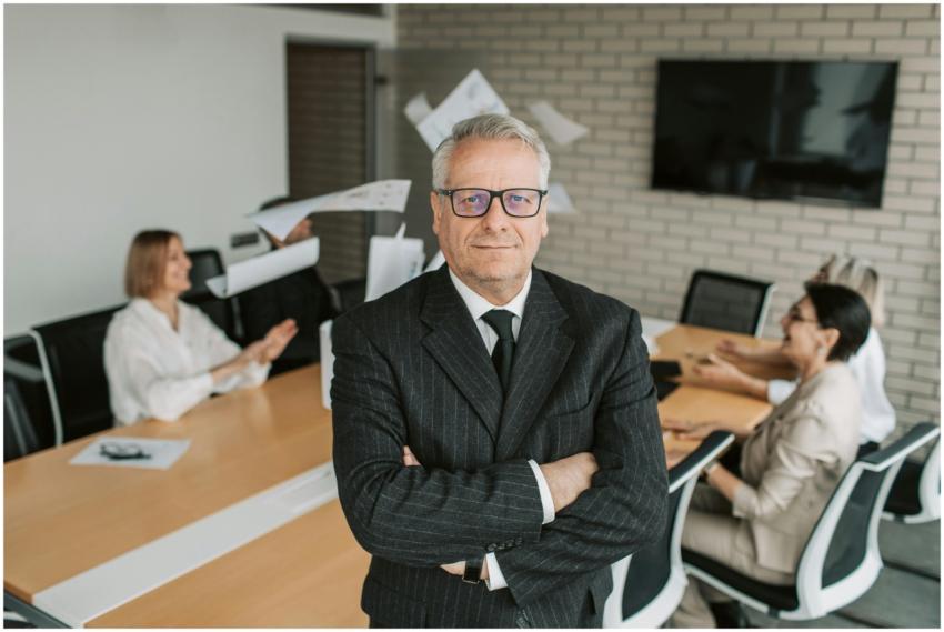 Business executive standing confidently in meeting