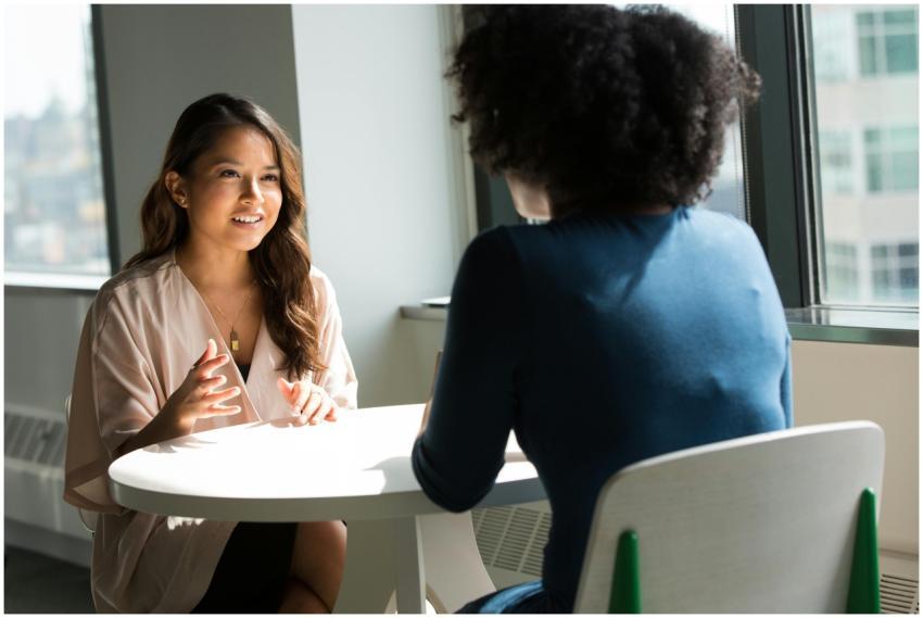 Two women sitting at a table having a professional