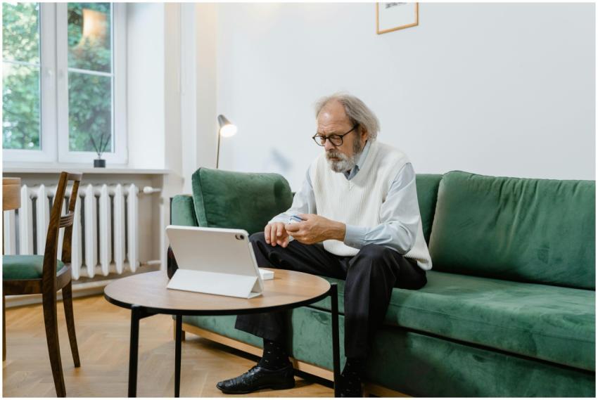 Elderly man engaged in online health consultation