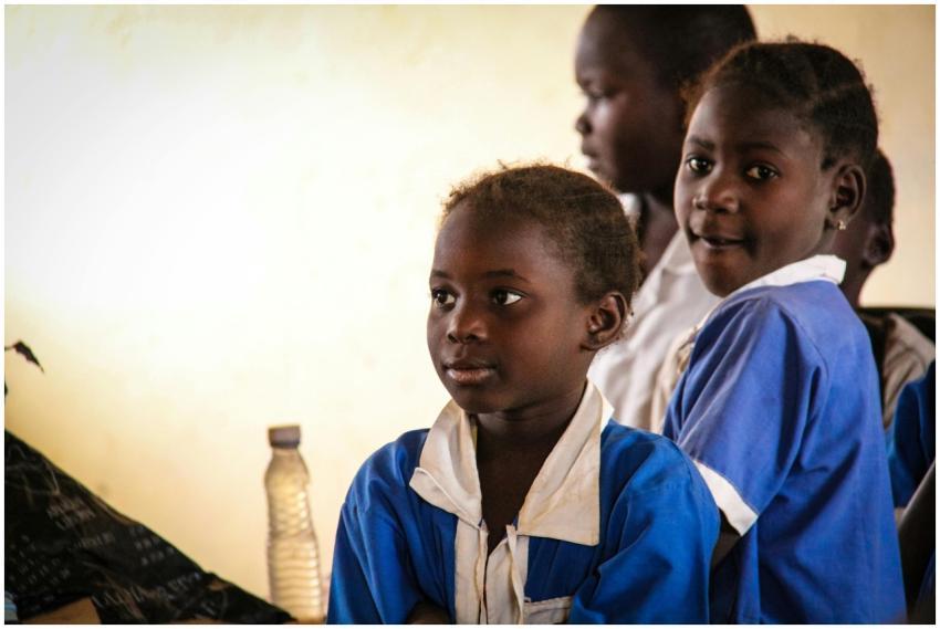 A group of children in school uniforms engaged in