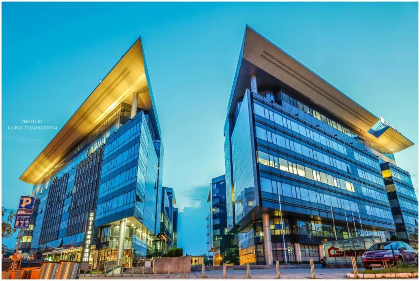 Futuristic glass office buildings at sunset in an