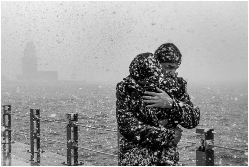 A moving black and white photo of a heartfelt embr