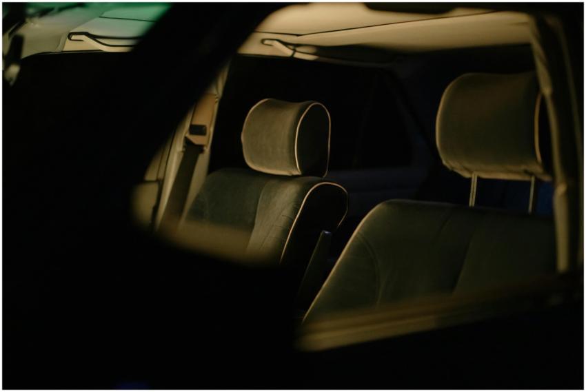 Close-up of car seats and headrests in a dimly lit