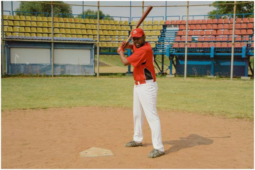 An African American man in a baseball uniform pois