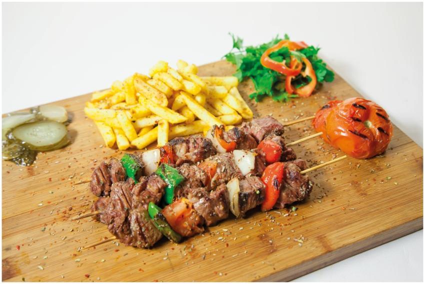 Delicious grilled shashlik served with seasoned fr