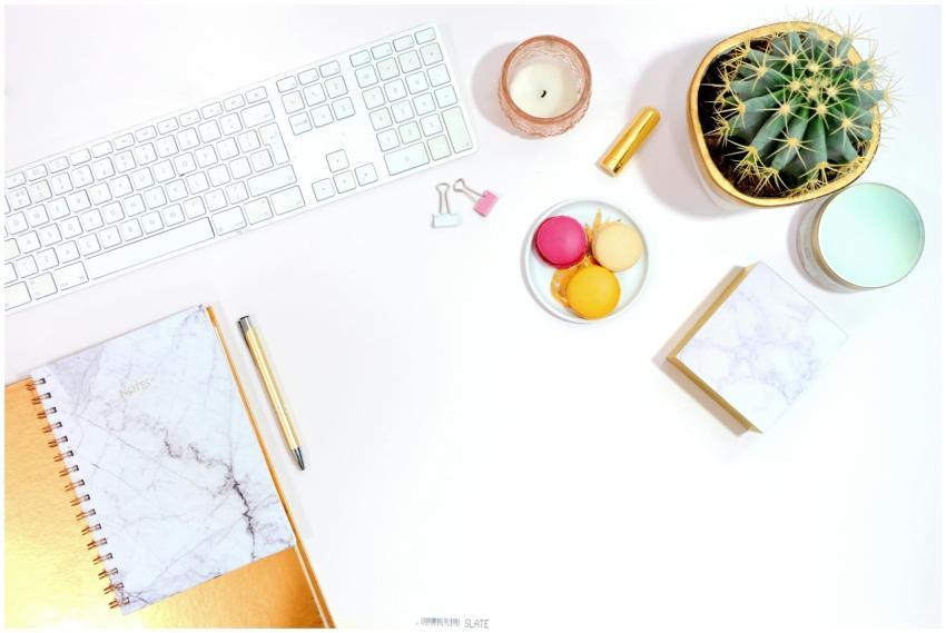 Minimalist office desk setup with cactus, keyboard