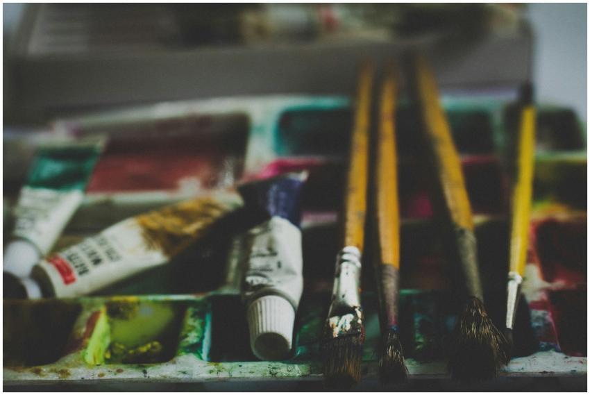 Close-up of paintbrushes and watercolor tubes on a