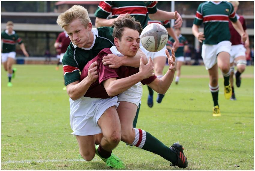 Players in action during a rugby match highlightin