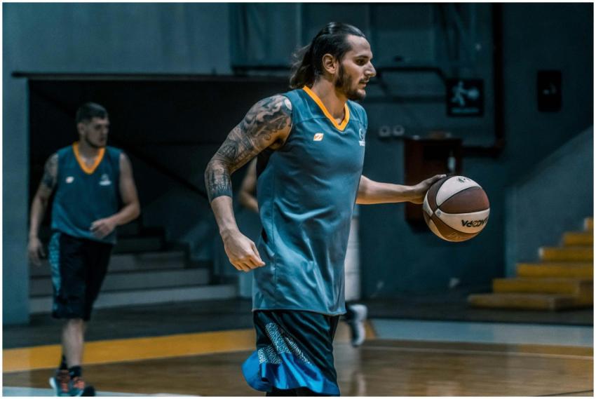 Athletes focused on basketball training indoors, e