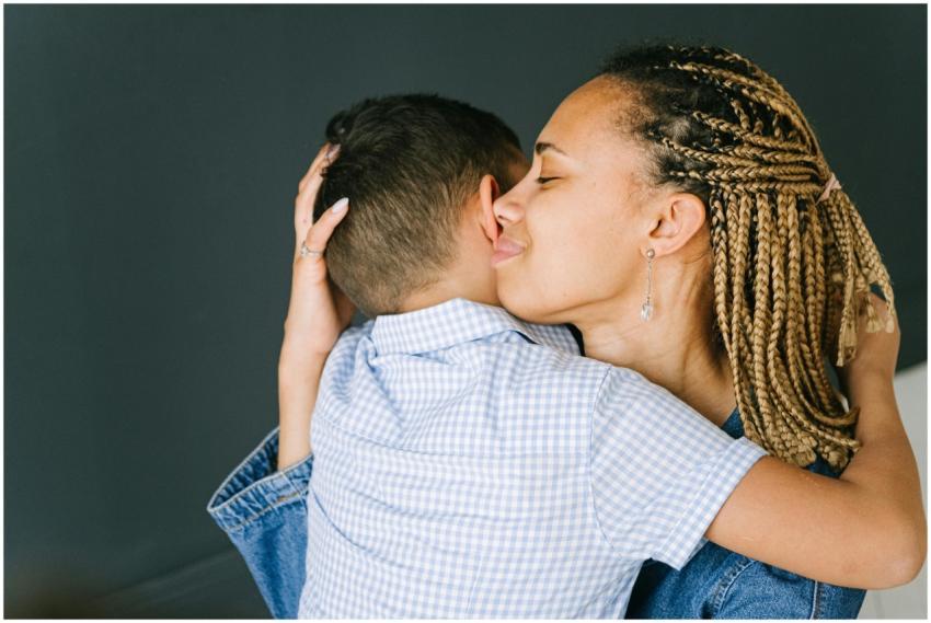 Tender moment of a mother embracing her child, exp